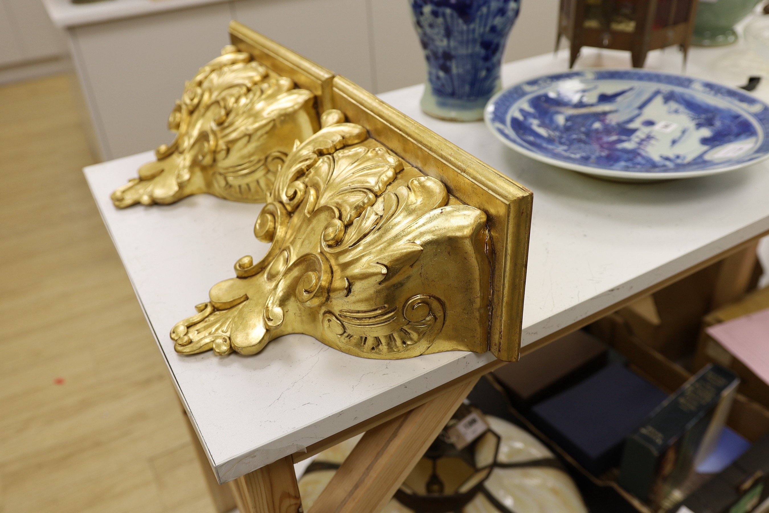 A pair of gilt wood wall brackets